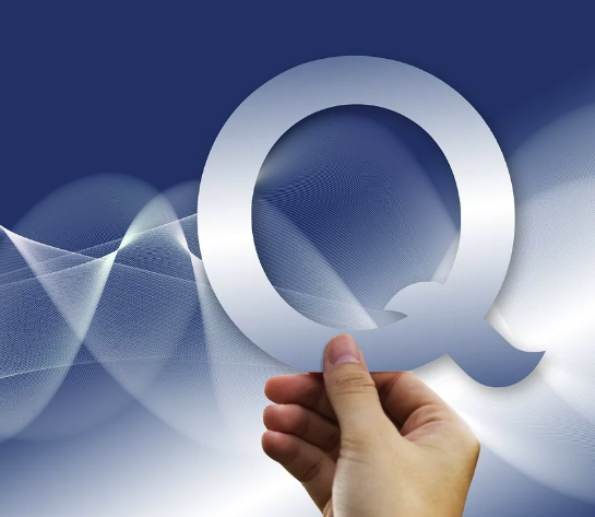 A hand holding a large letter Q against a navy background with flowing white wave patterns